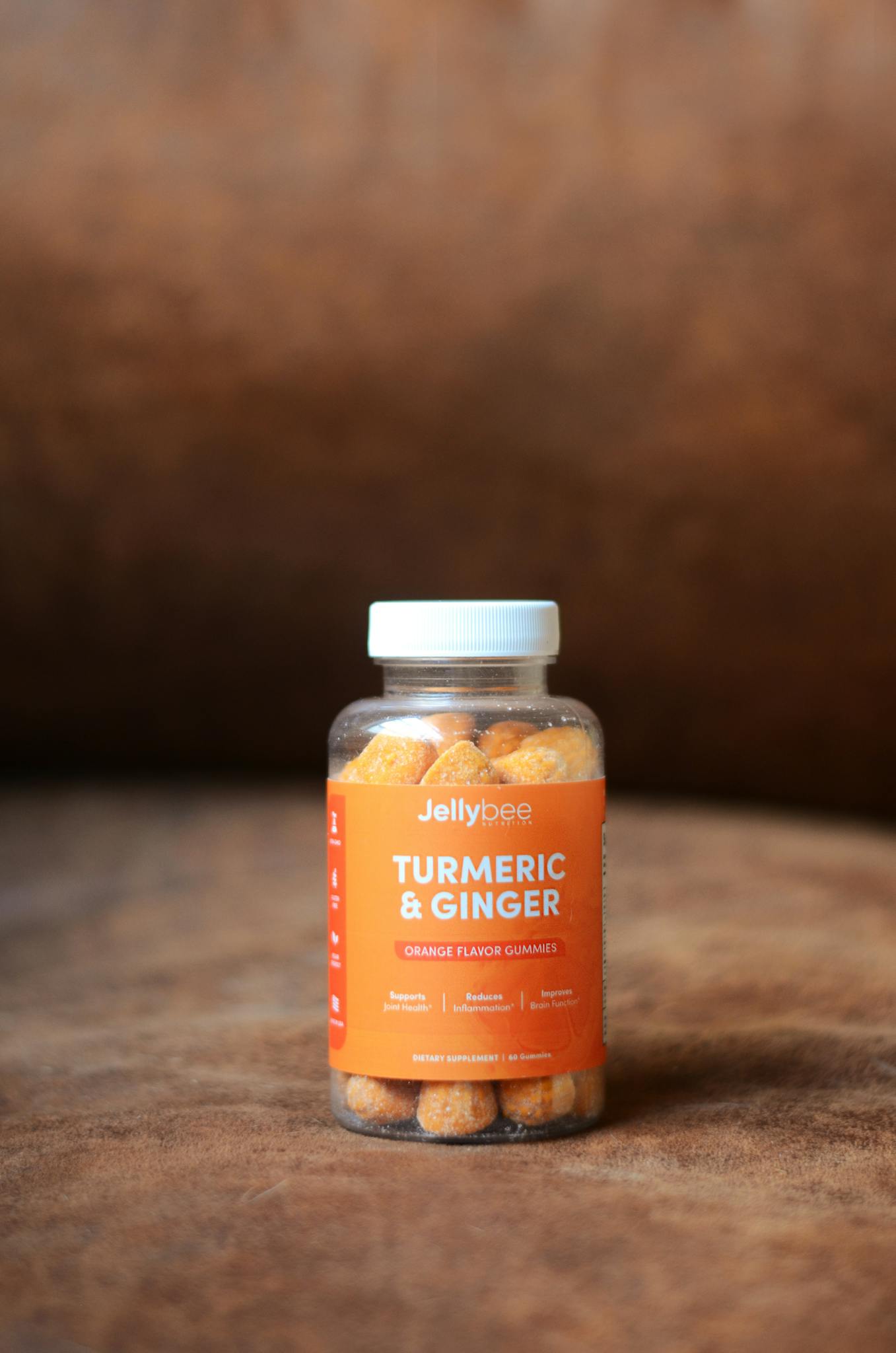 Bottle of Jellybee turmeric and ginger gummies promoting health and immunity with orange flavor.