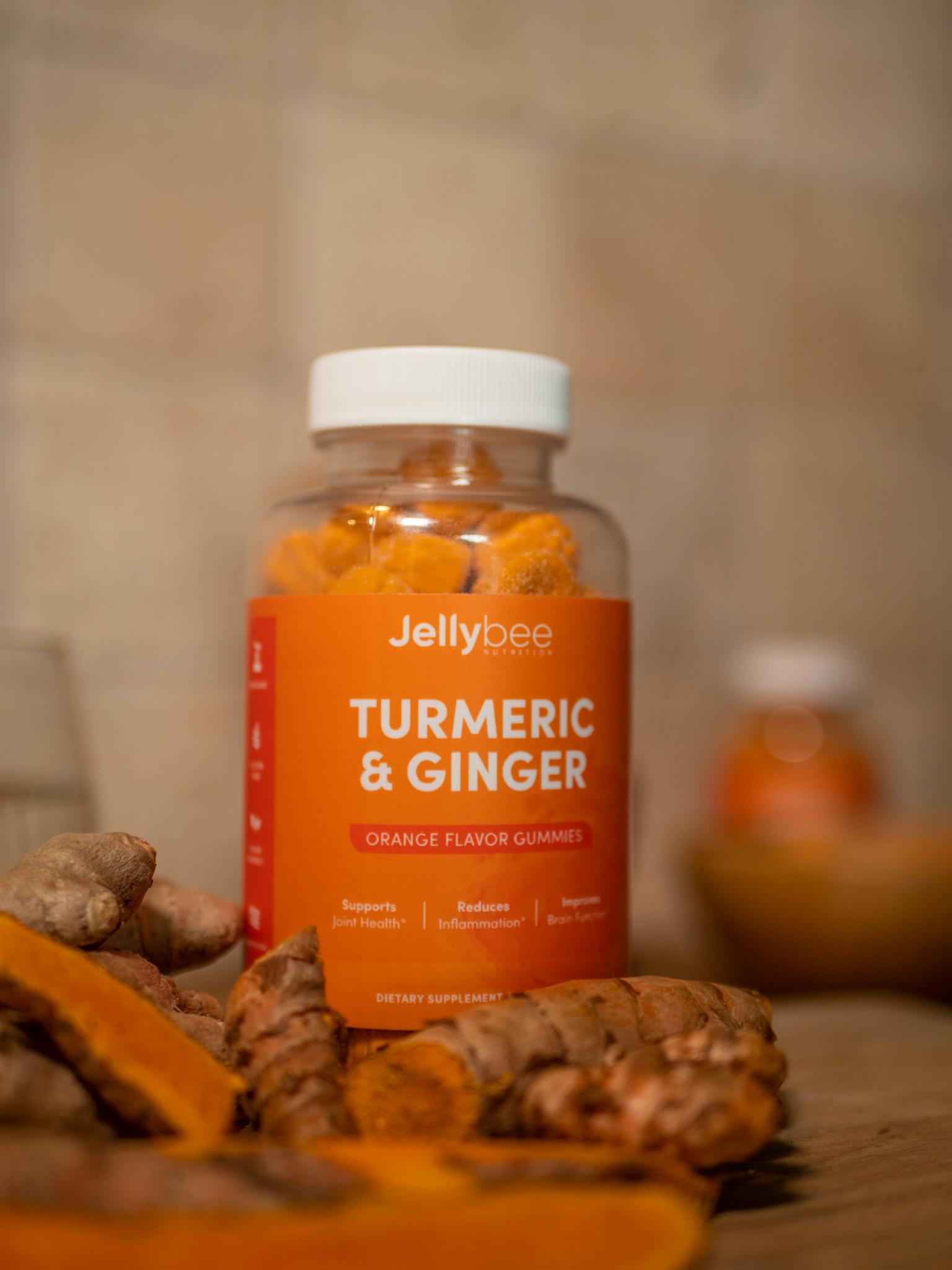 Close-up of Jellybee turmeric and ginger orange flavor gummies for health and nutrition.